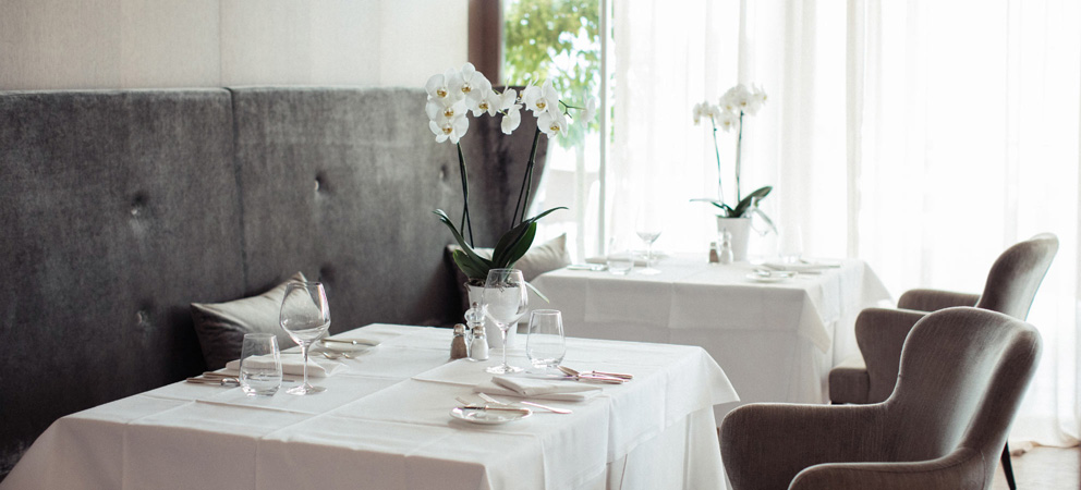 a table set in the bright dining room of the hotel Giardino Marling